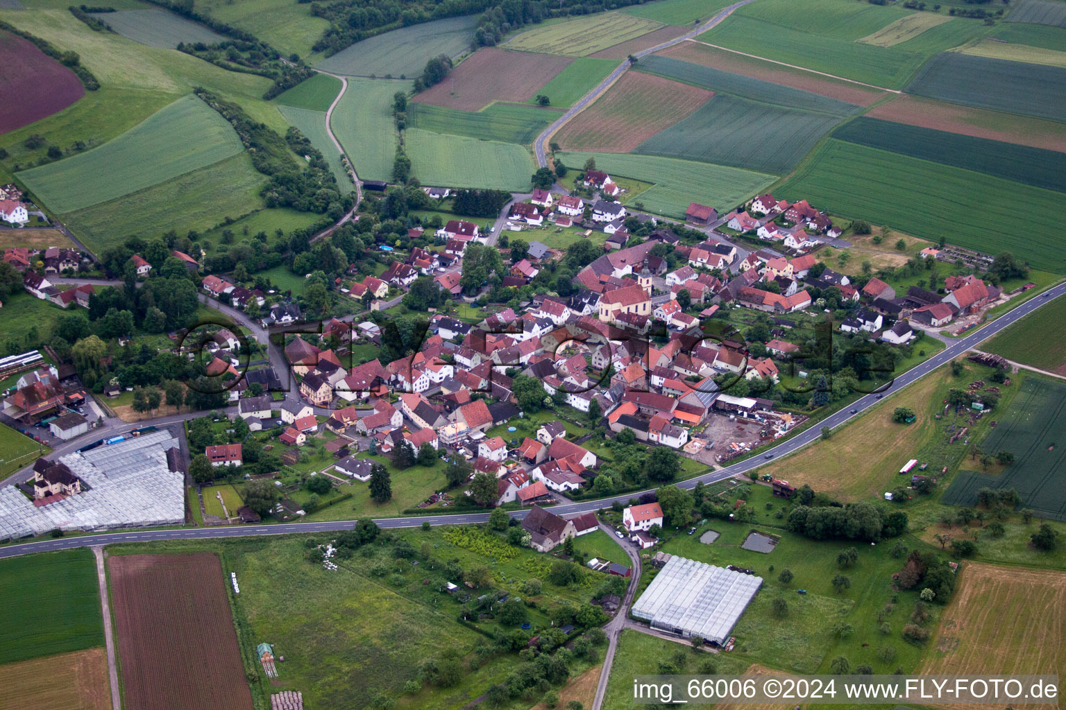 Village - view on the edge of agricultural fields and farmland in Karsbach in the state Bavaria, Germany