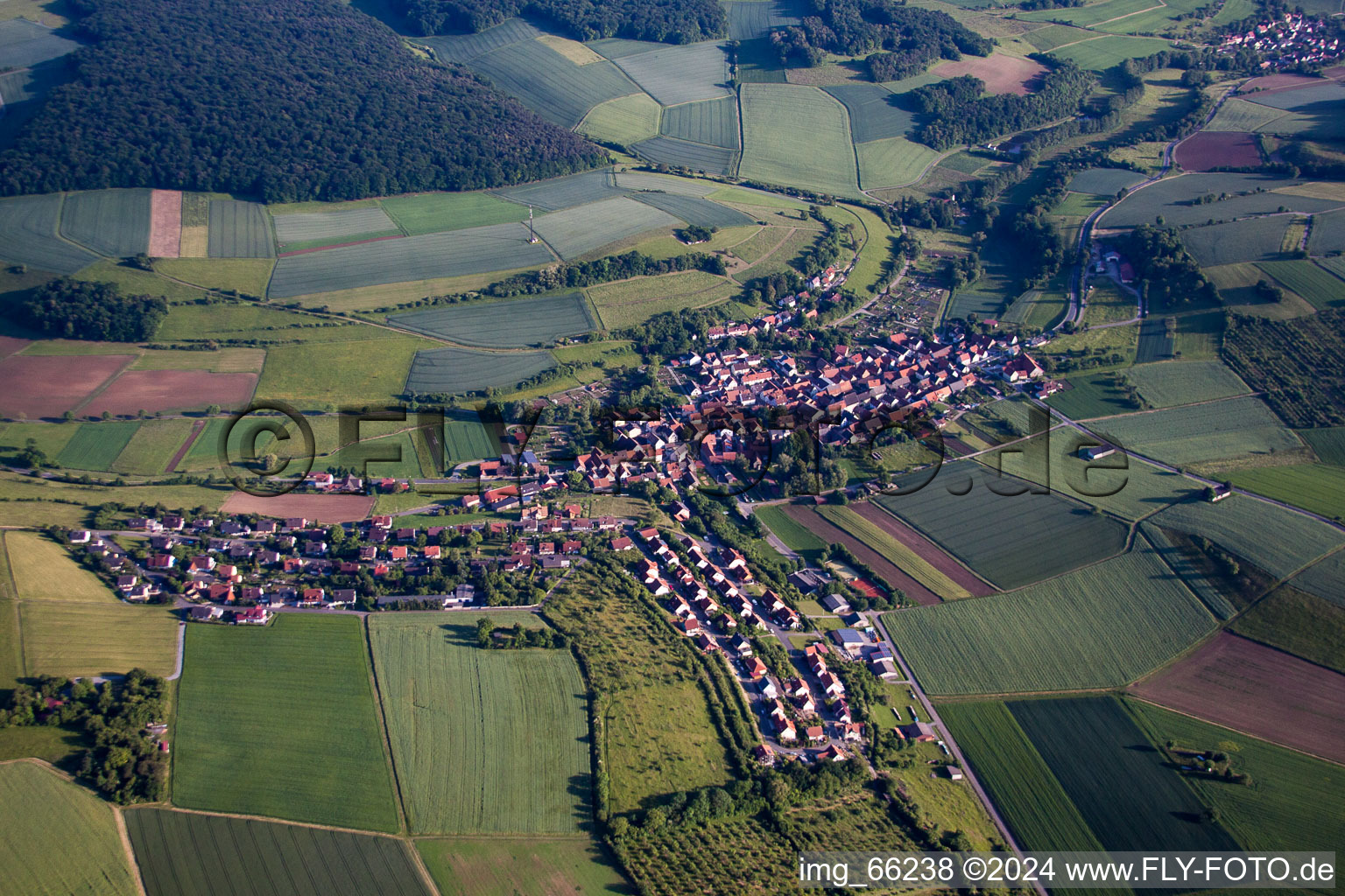 Village - view on the edge of agricultural fields and farmland in Unteraltertheim in the state Bavaria, Germany