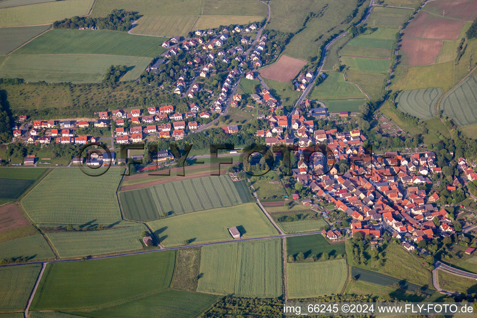 Aerial view of Village - view on the edge of agricultural fields and farmland in Unteraltertheim in the state Bavaria, Germany