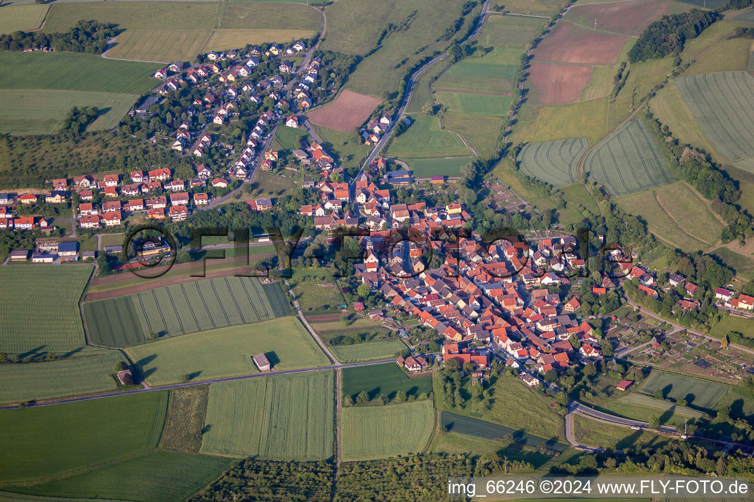 Aerial photograpy of Village - view on the edge of agricultural fields and farmland in Unteraltertheim in the state Bavaria, Germany