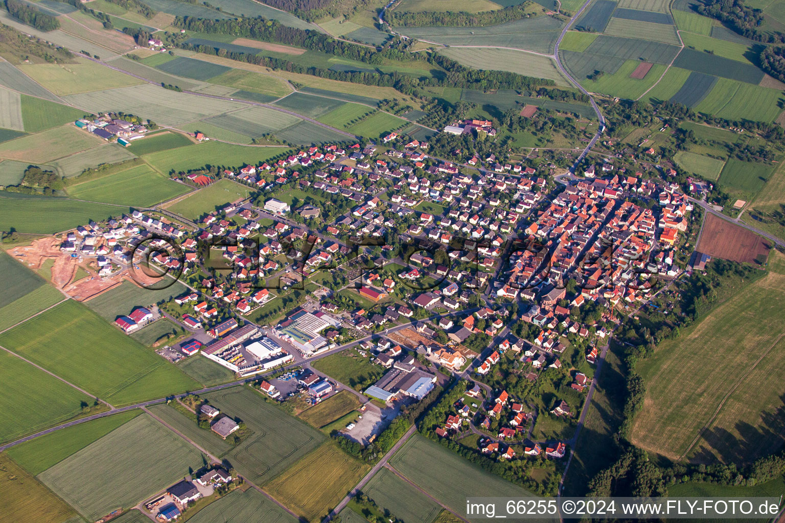 Aerial photograpy of Village - view on the edge of agricultural fields and farmland in Werbach in the state Baden-Wurttemberg, Germany