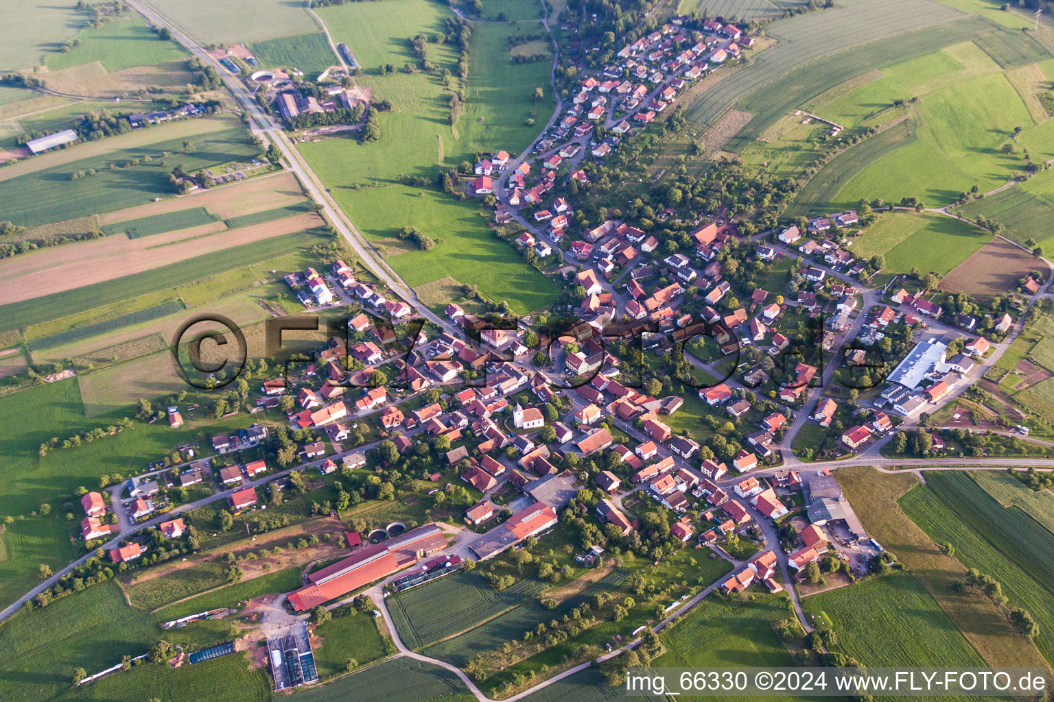 Aerial view of Village - view on the edge of agricultural fields and farmland in Schollbrunn in the state Baden-Wurttemberg, Germany