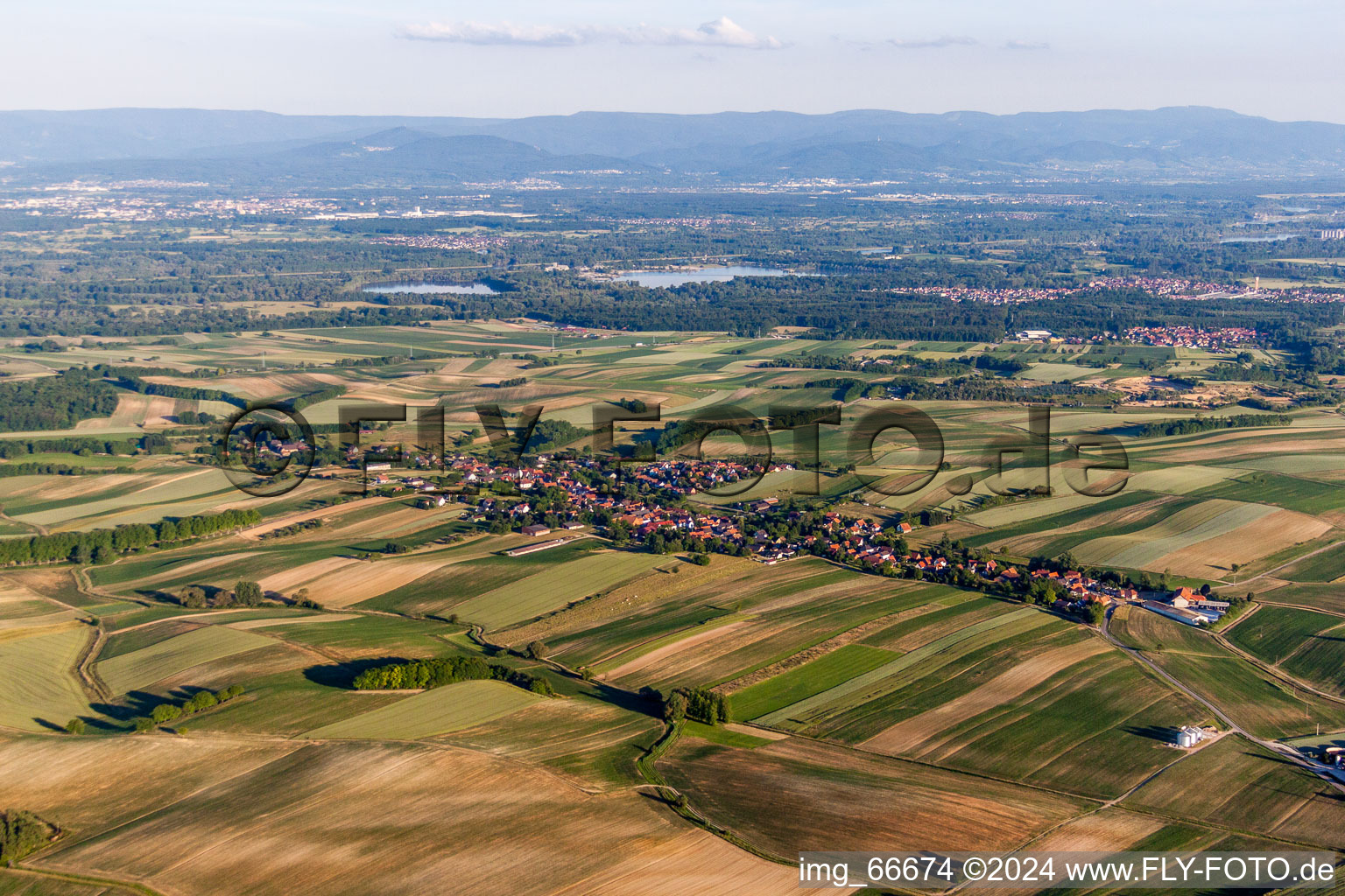 Aerial view of Village - view on the edge of agricultural fields and farmland in Wintzenbach in Grand Est, France