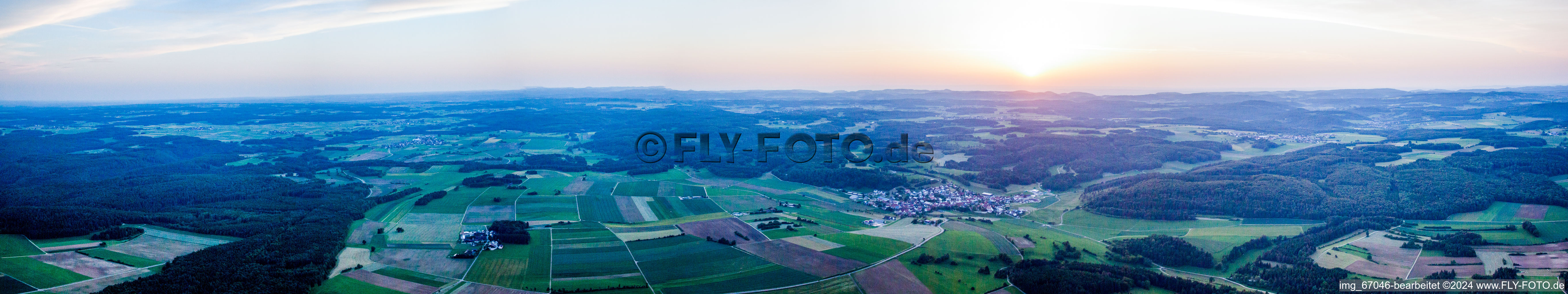 Panoramic perspective at sunset of Village - view on the edge of agricultural fields and farmland in Hayingen in the state Baden-Wurttemberg, Germany