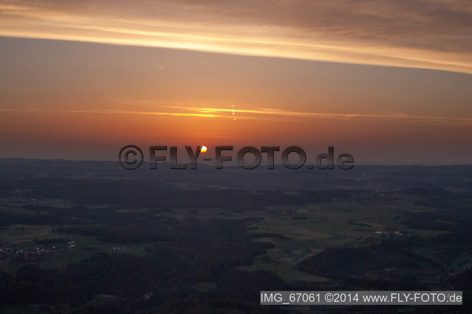 Aerial photograpy of Sunset over the countryside in Ehingen (Donau) in the state Baden-Wurttemberg dyes the sky in a red and orange colour