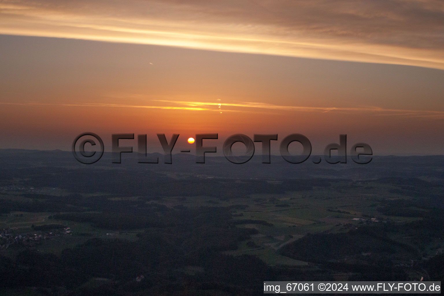 Aerial photograpy of Sunset over the countryside in Ehingen (Donau) in the state Baden-Wurttemberg dyes the sky in a red and orange colour