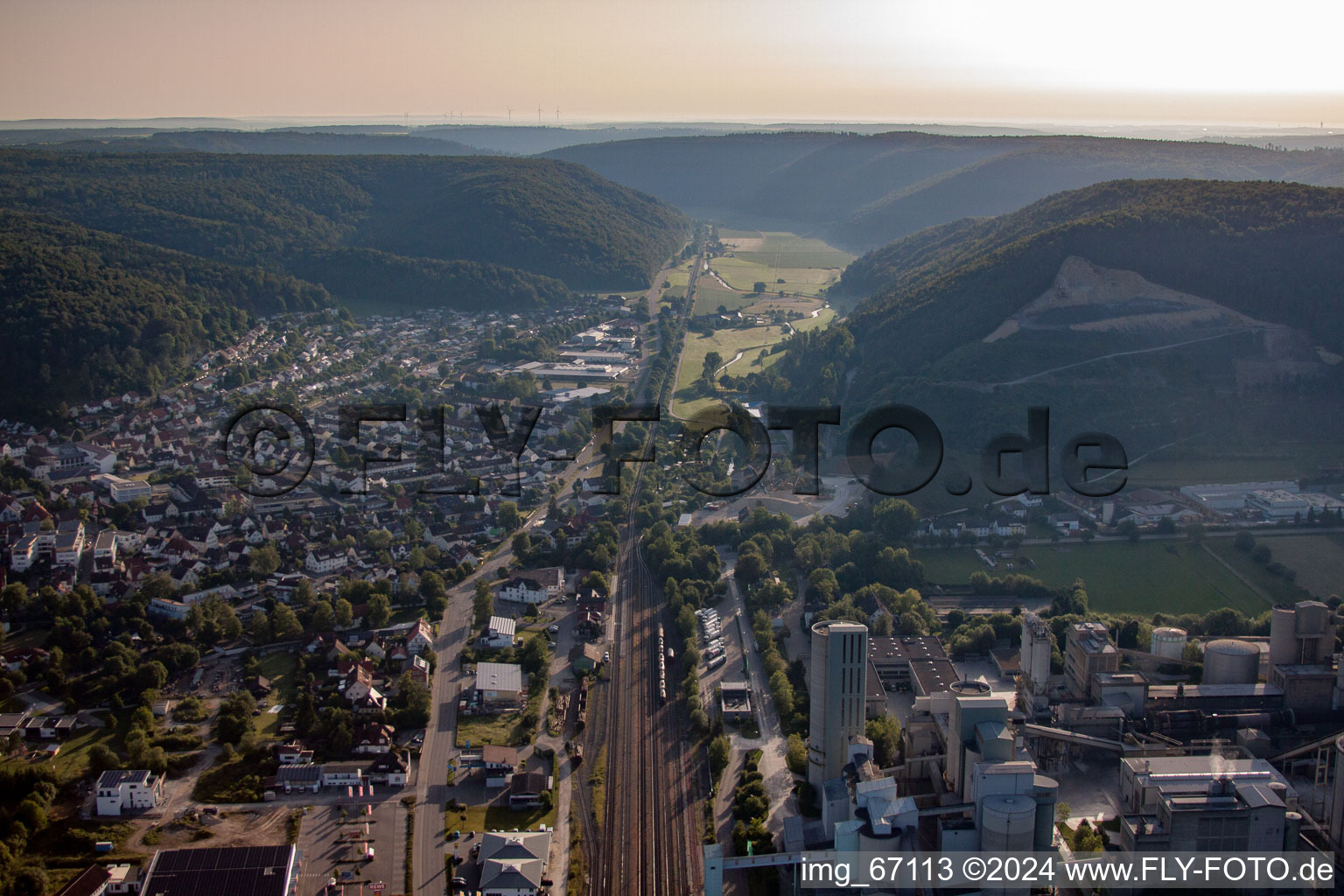 Train between town and Heidelberg Materials in Schelklingen in the state Baden-Wuerttemberg, Germany