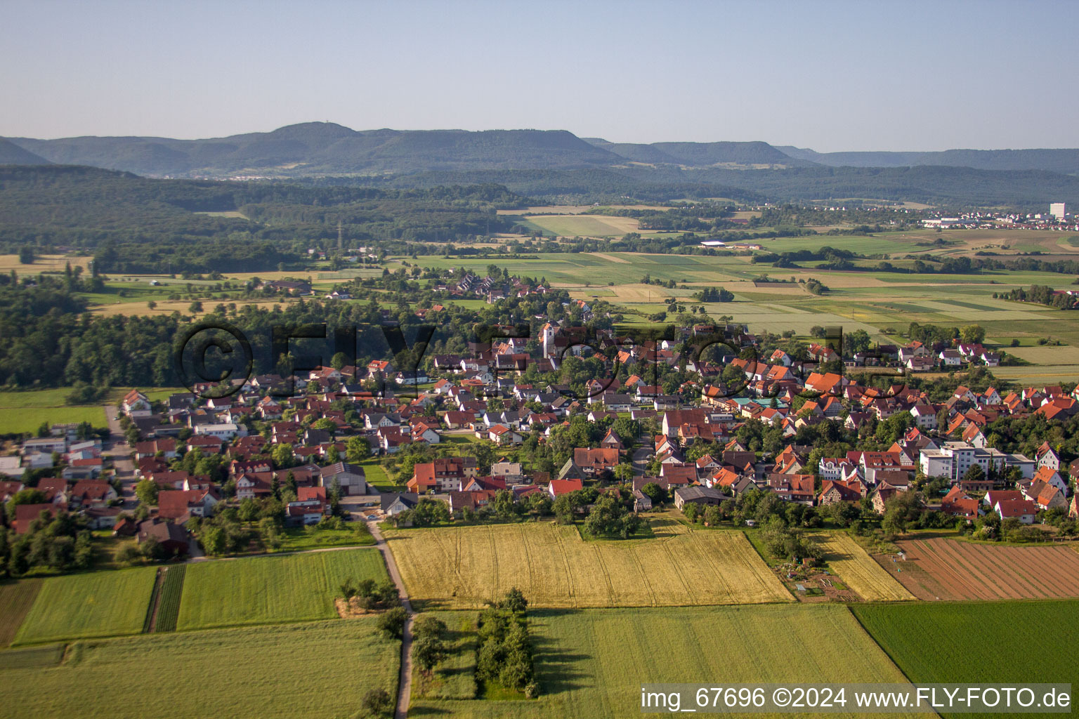 Village - view on the edge of agricultural fields and farmland in the district Maehringen in Kusterdingen in the state Baden-Wurttemberg, Germany
