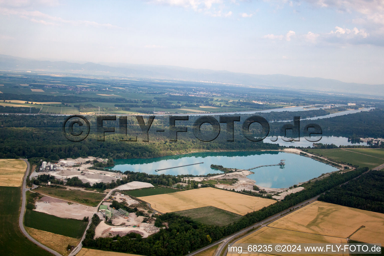 Mixed concrete and building materials factory of Birkenmeier Stein+Design in Gravel mine in the district Niederrimsingen in Breisach am Rhein in the state Baden-Wurttemberg, Germany seen from above