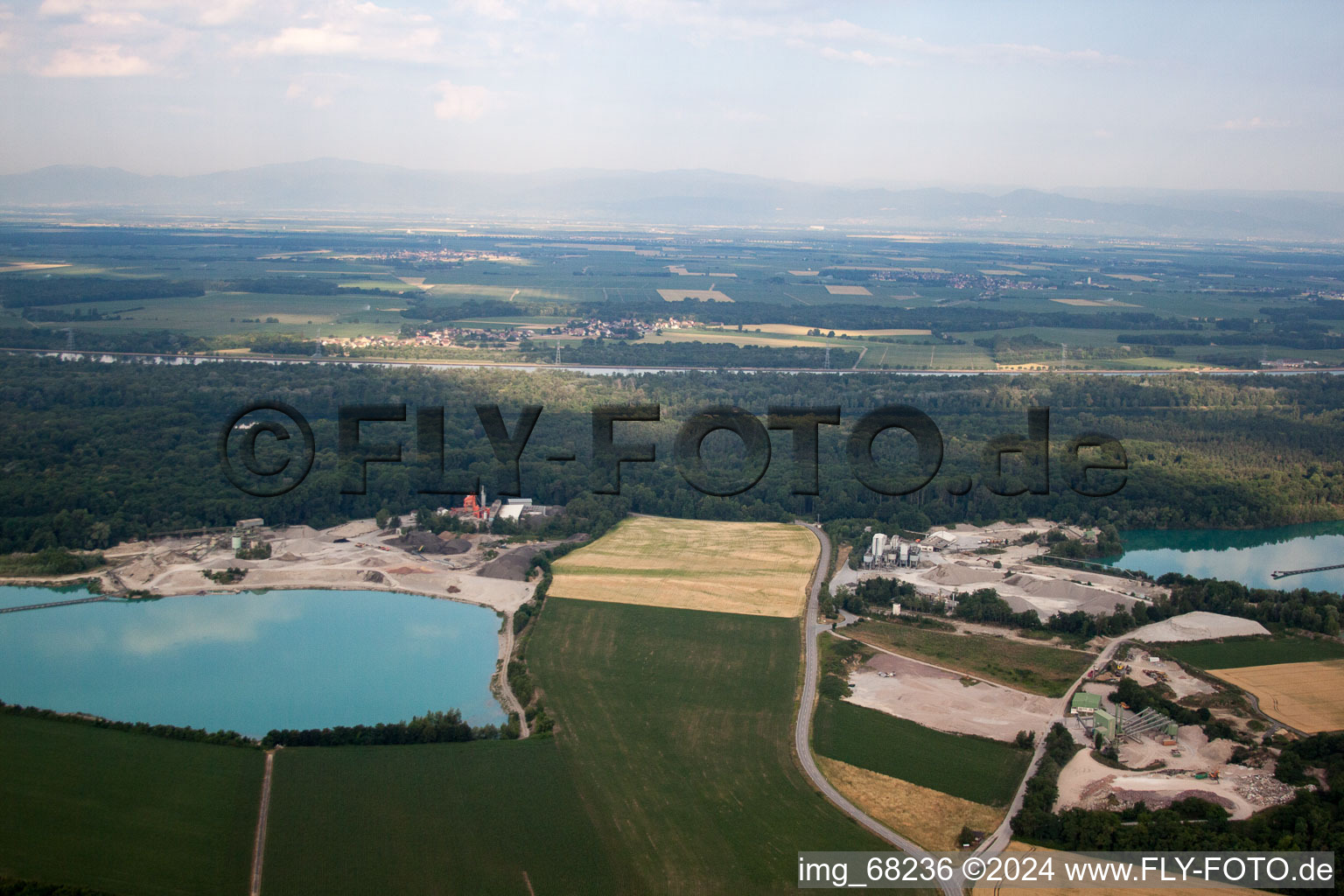 Mixed concrete and building materials factory of Birkenmeier Stein+Design in Gravel mine in the district Niederrimsingen in Breisach am Rhein in the state Baden-Wurttemberg, Germany from the plane