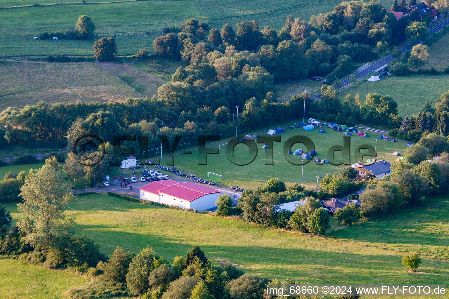 Football field with tent camp in the district Burkhards in Schotten in the state Hesse, Germany