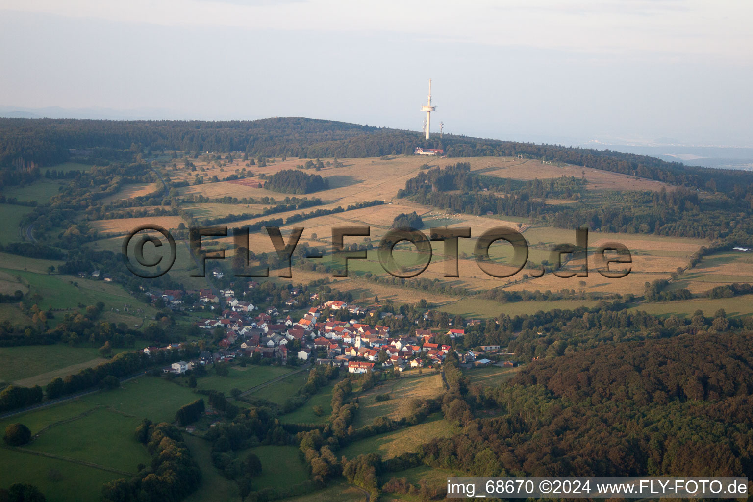 Village - view on the edge of agricultural fields and farmland in Breungeshain in the state Hesse