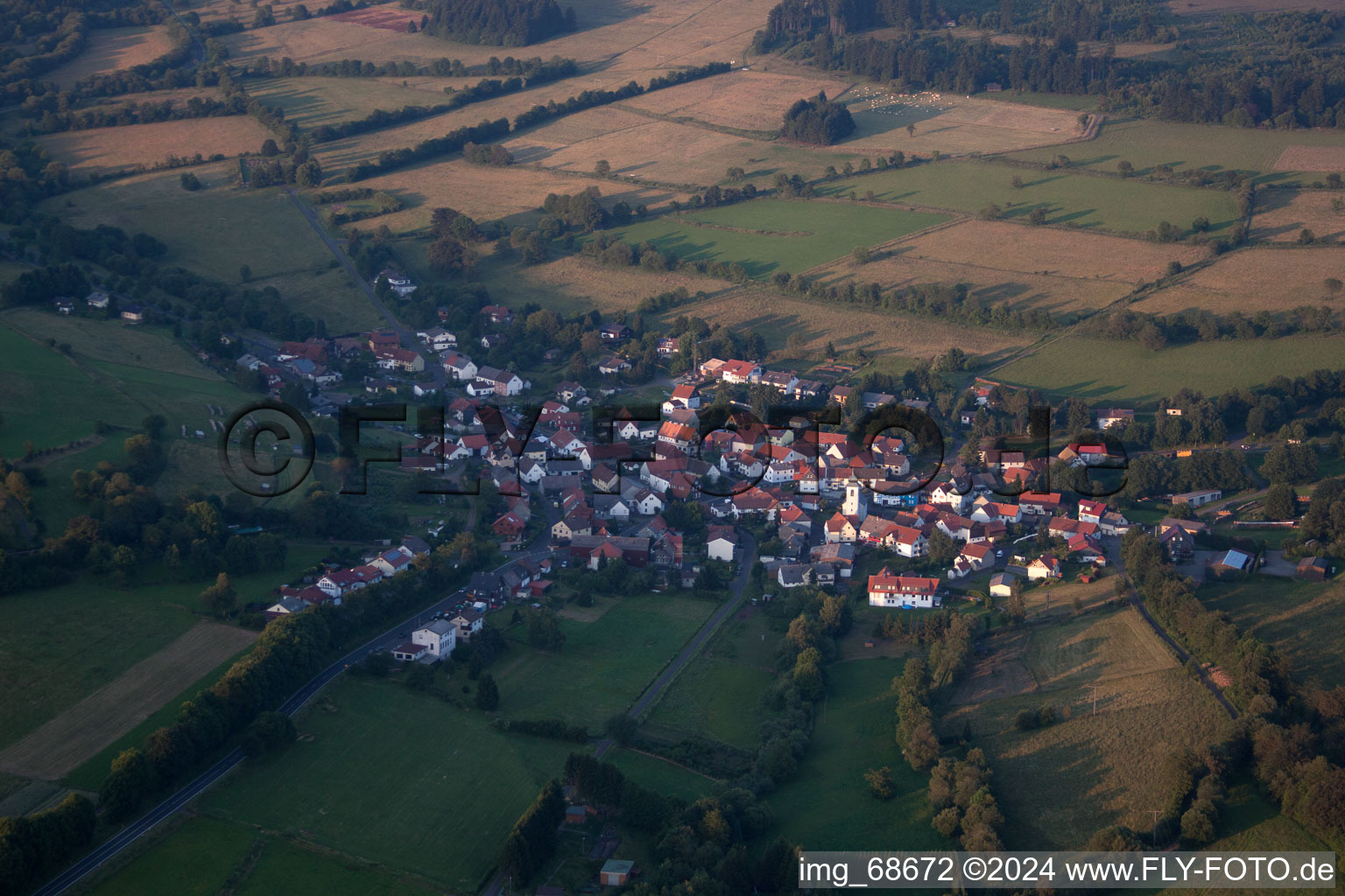 Aerial view of Village - view on the edge of agricultural fields and farmland in Breungeshain in the state Hesse