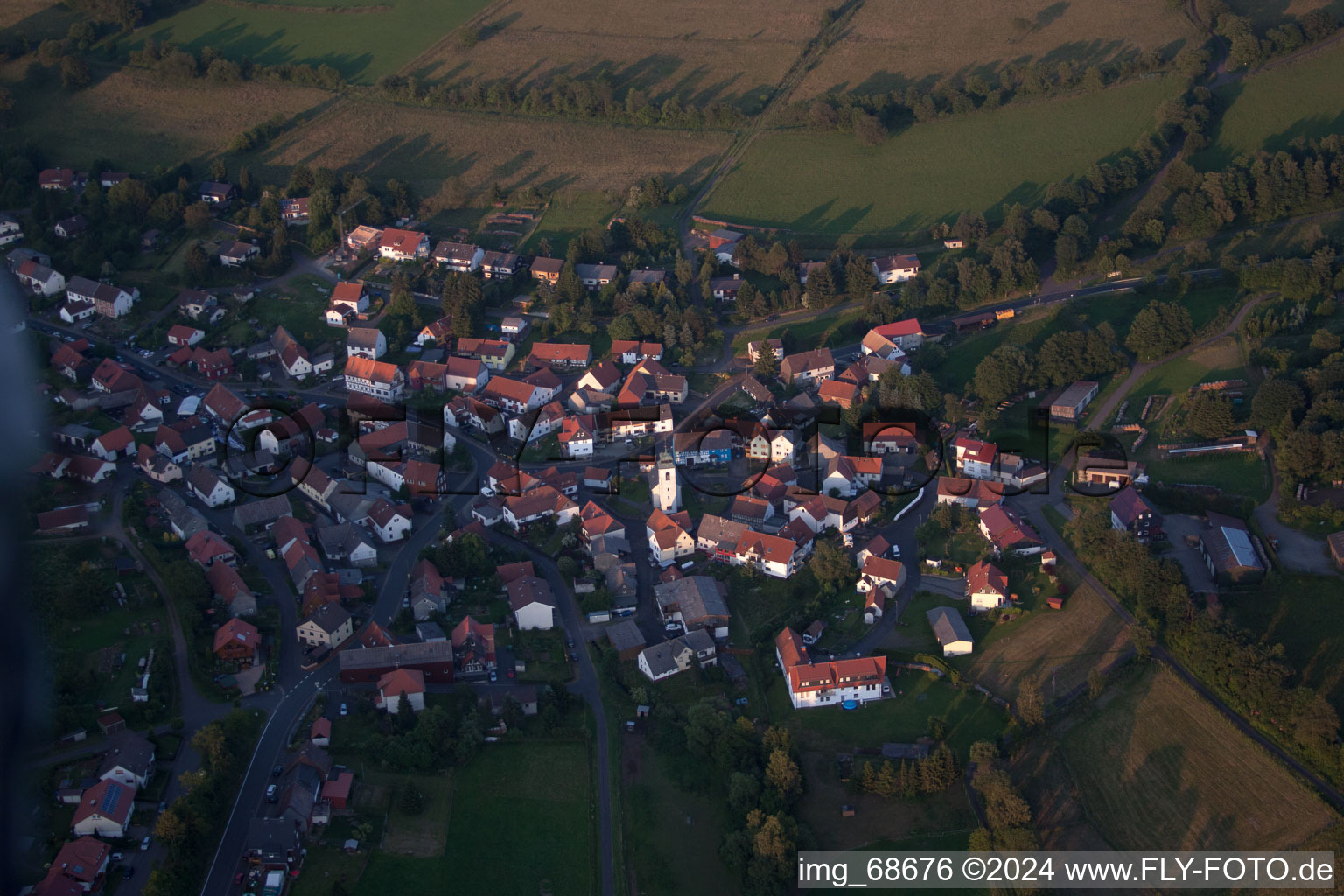 Oblique view of Village - view on the edge of agricultural fields and farmland in Breungeshain in the state Hesse