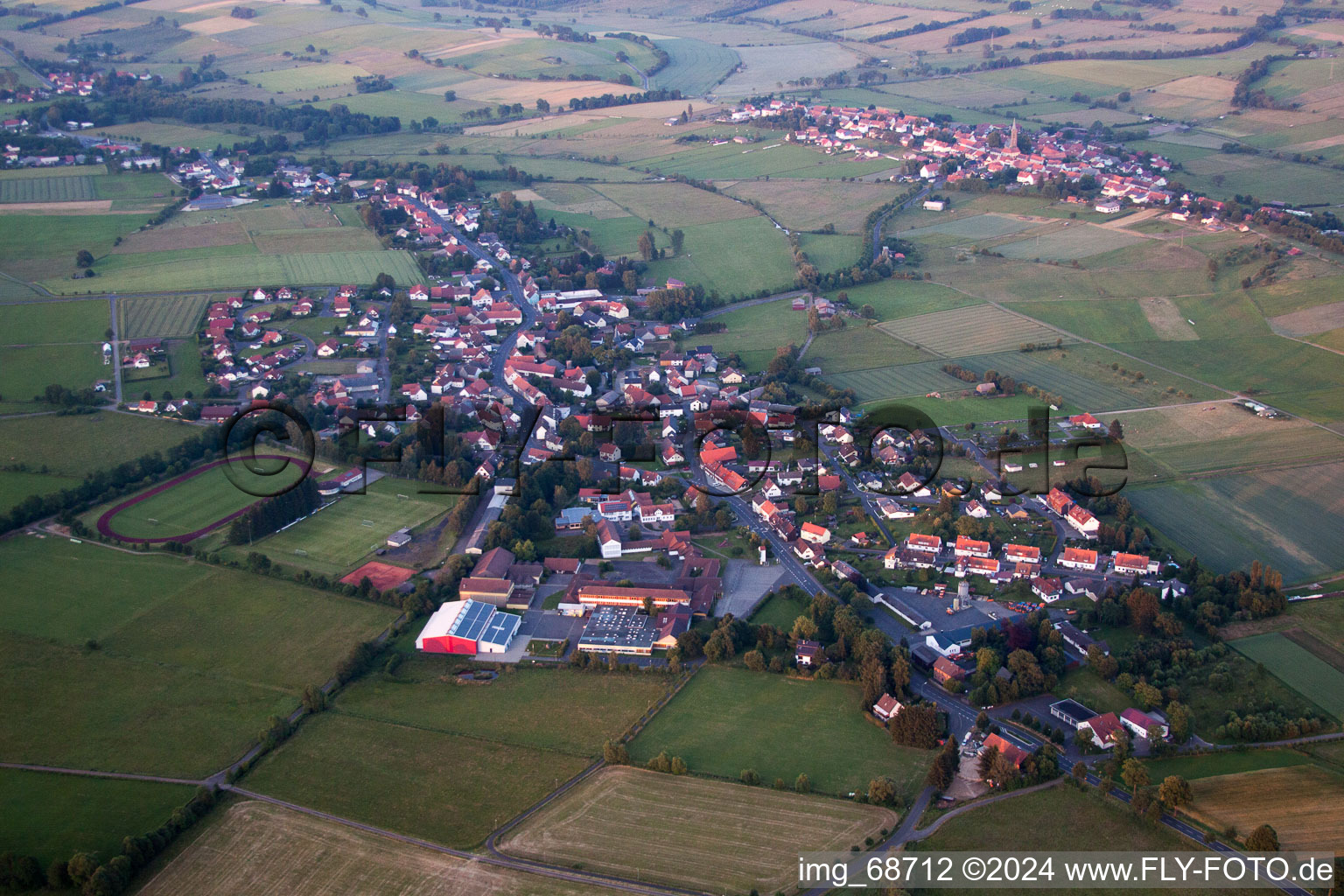 Village - view on the edge of agricultural fields and farmland in Grebenhain in the state Hesse, Germany