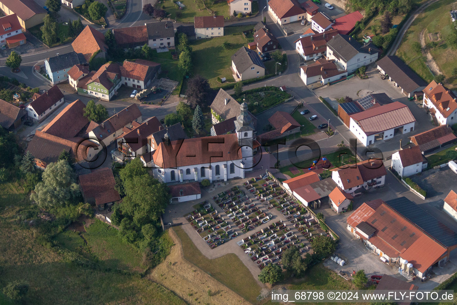 Grave rows on the grounds of the cemetery and church of in Oberleichtersbach in the state Bavaria, Germany