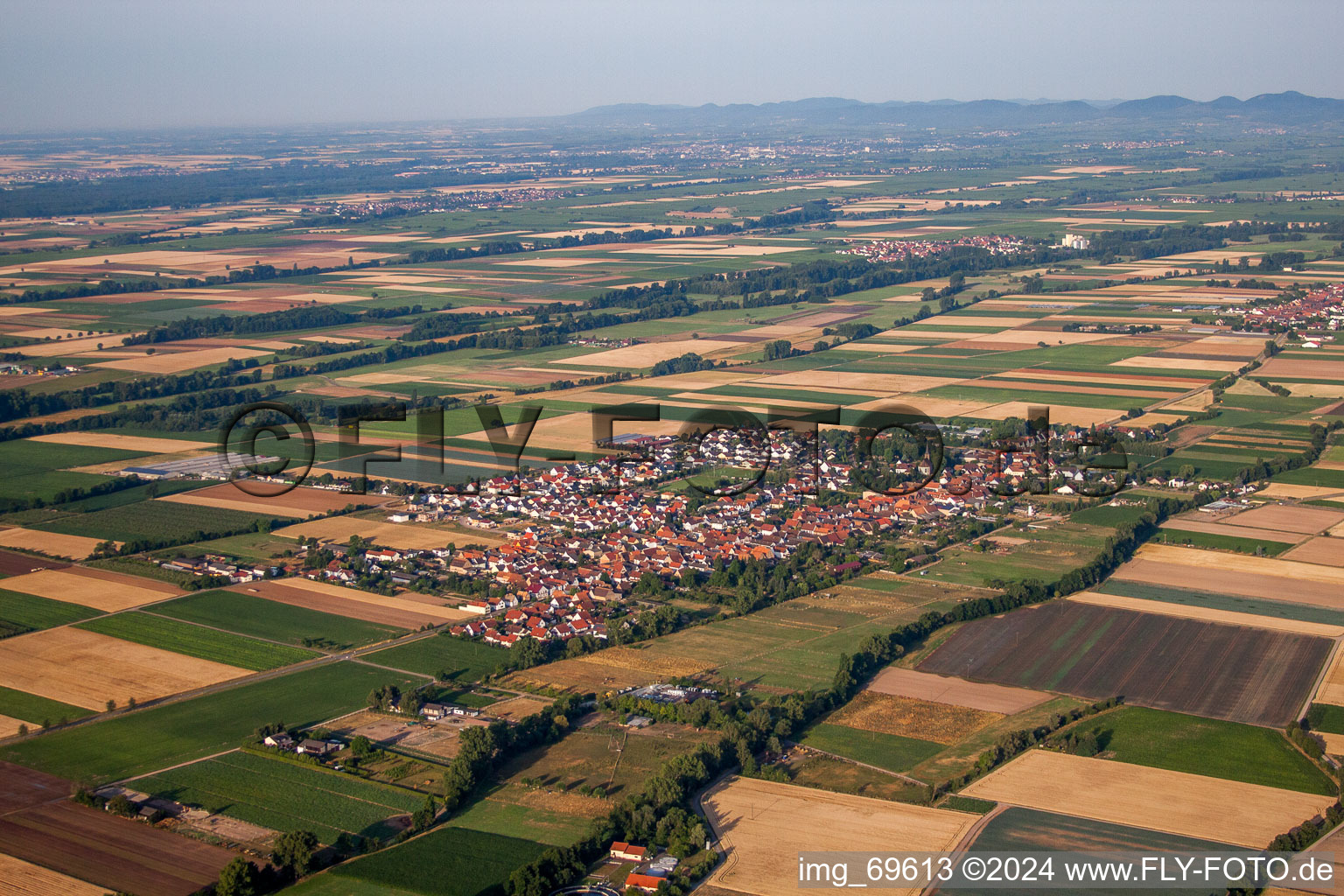 Village - view on the edge of agricultural fields and farmland in Gommersheim in the state Rhineland-Palatinate, Germany