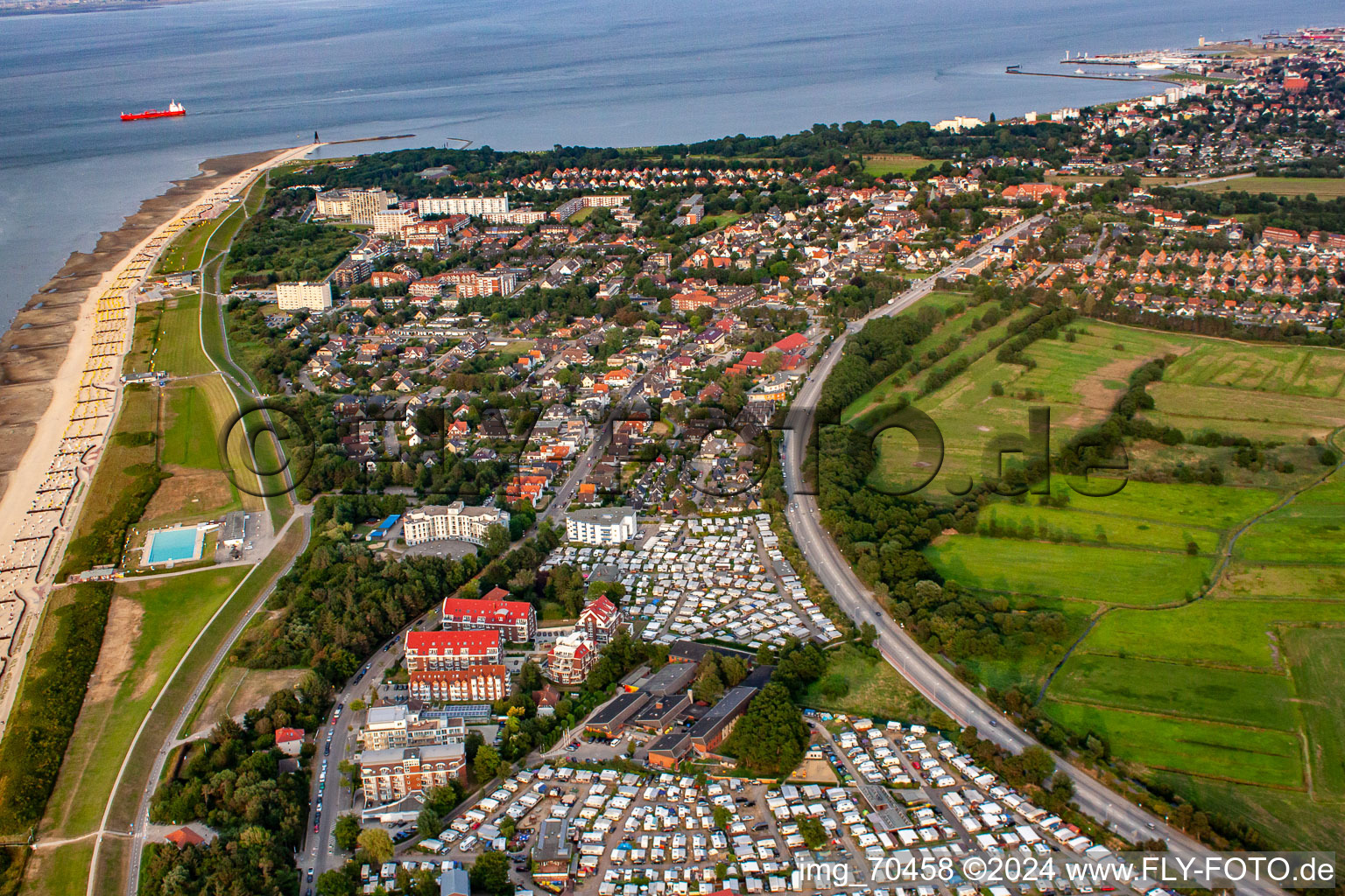 Rows of beach chairs on the sandy beach up to the Kugelbake in the coastal area of the North Sea with the Wattenlöper and Nordsee campsites in the foreground in the district Duhnen in Cuxhaven in the state Lower Saxony, Germany