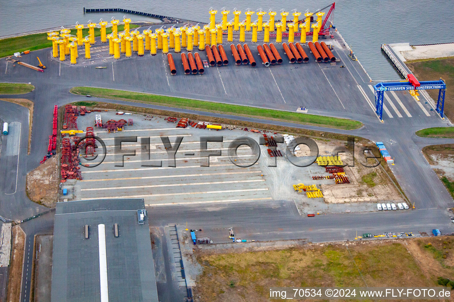 Aerial view of Port facilities on the sea coast of Cuxport GmbH for offshore wind turbines in Cuxhaven in the state Lower Saxony, Germany