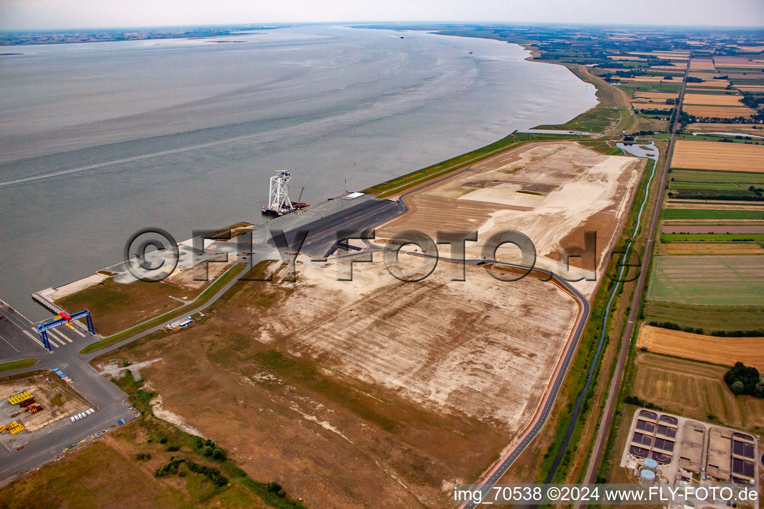 Aerial photograpy of Port facilities on the sea coast of Cuxport GmbH for offshore wind turbines in Cuxhaven in the state Lower Saxony, Germany