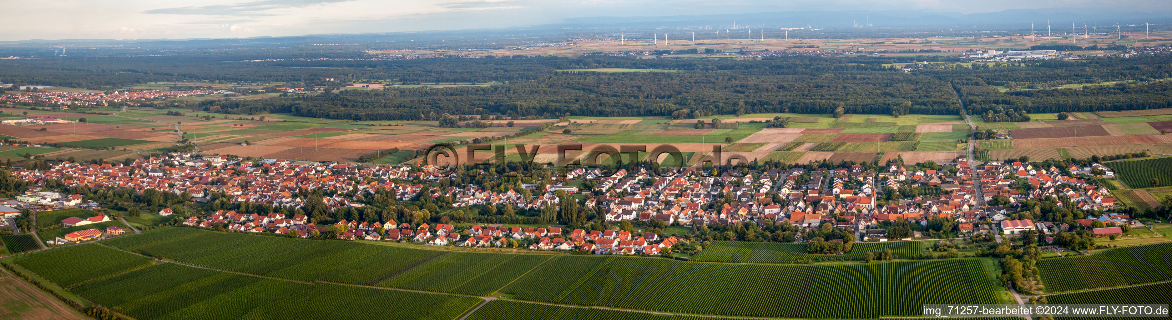 Aerial view of Panoramic perspective Village - view on the edge of agricultural fields and farmland in Hochstadt (Pfalz) in the state Rhineland-Palatinate, Germany