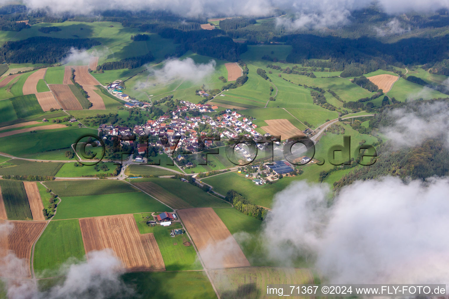 Village - view below low clouds on the edge of agricultural fields and farmland in the district Mauenheim in Immendingen in the state Baden-Wurttemberg, Germany