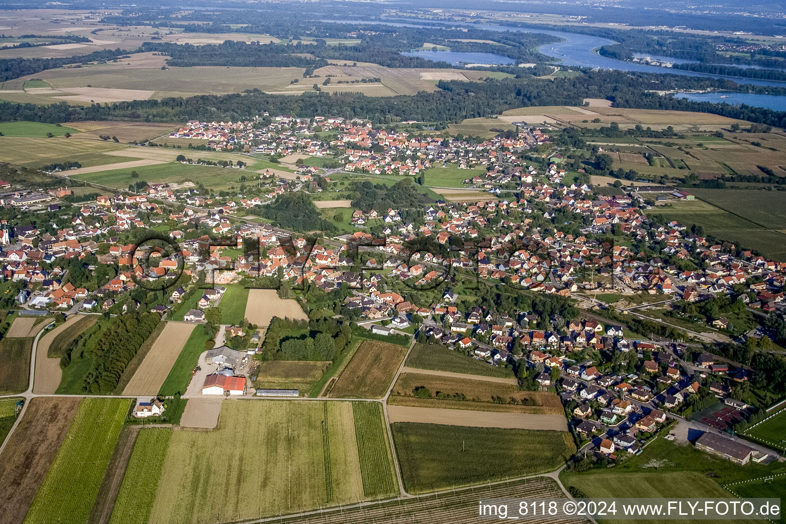 Aerial view of Village - view on the edge of agricultural fields and farmland in Sessenheim in Grand Est, France