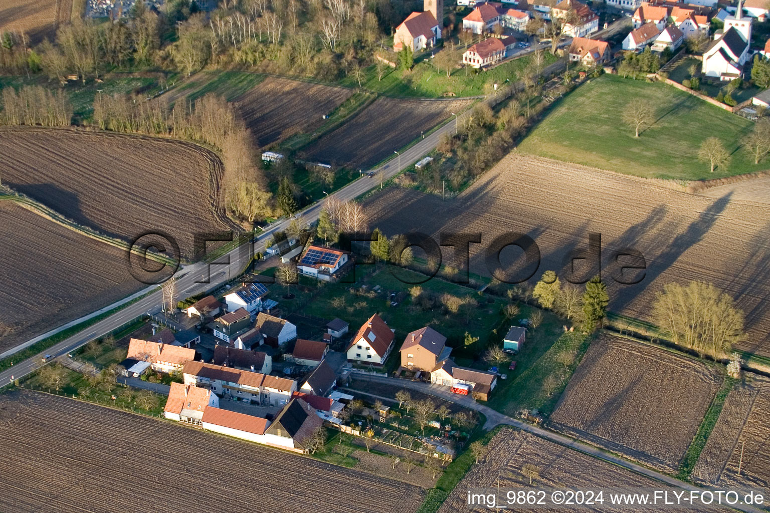 Village - view on the edge of agricultural fields and farmland in Minfeld in the state Rhineland-Palatinate out of the air