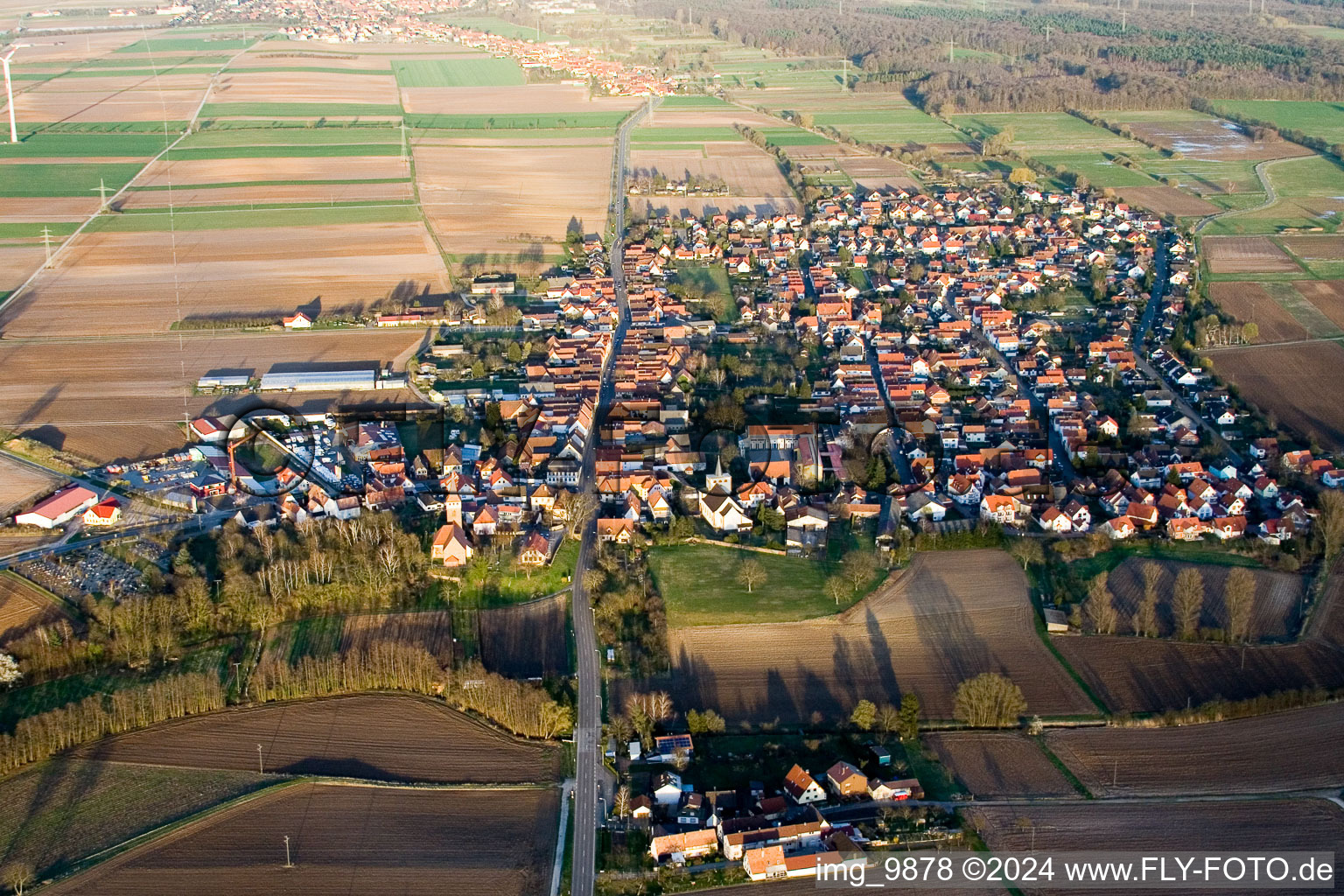 Village - view on the edge of agricultural fields and farmland in Minfeld in the state Rhineland-Palatinate seen from above