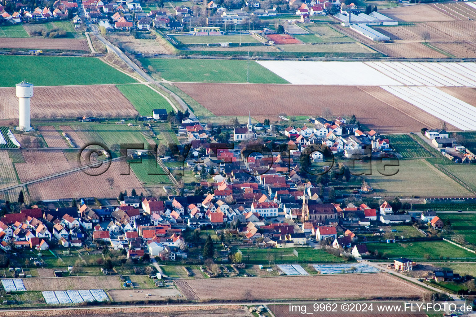 Village - view on the edge of agricultural fields and farmland in Lustadt in the state Rhineland-Palatinate