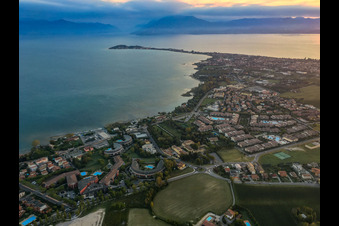 Sirmione peninsula on Lake Garda in the morning light in Desenzano del Garda in the state Brescia, Italy