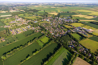 Agricultural land and field boundaries surround the settlement area of the village in Bargenstedt in the state Schleswig-Holstein, Germany