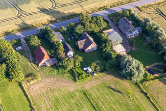 Former dike keepers' farms on Schülpersieler Straße in Wesselburenerkoog in the state Schleswig Holstein, Germany from the plane
