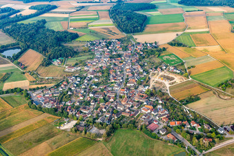Aerial view of Agricultural land and field borders surround the settlement area of the village in Moos in the state Baden-Wuerttemberg, Germany