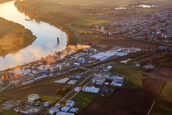 Pharmaceutical factory on the banks of the Rhine in the evening Merck KGaA - Site Gernsheim in Gernsheim in the state Hesse, Germany