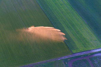 Water sprinklers for field irrigation in the evening light in Einhausen in the state Hesse, Germany