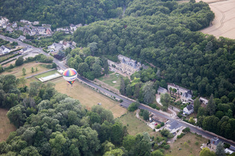 Oblique view of Hot air balloon launch in front of Chateau de Perreux in Nazelles-Negron in Centre-Val de Loire, France