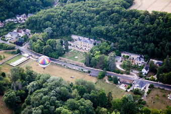 Hot air balloon launch in front of Chateau de Perreux in Nazelles-Negron in Centre-Val de Loire, France from above