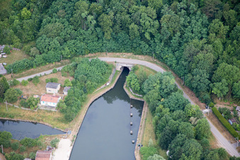 Aerial view of Channel flow through tunnel and river banks of the waterway shipping Rhine to Marne channel in Foug in Grand Est, France