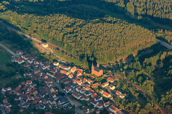 Queichtal railway line with church Wilgartswiesen in the evening light in Wilgartswiesen in the state Rhineland-Palatinate, Germany