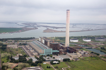 Tanks, power plants and exhaust towers of the oil-fired power plant at the mouth of the Po in Case Ocaro in the state Veneto, Italy