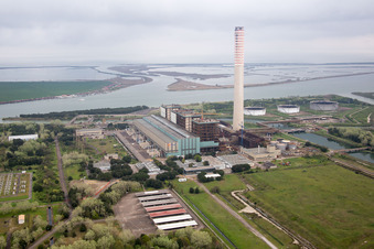 Aerial view of Tanks, power plants and exhaust towers of the oil-fired power plant at the mouth of the Po in Case Ocaro in the state Veneto, Italy