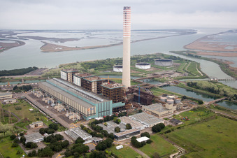 Aerial view of Tanks, power plants and exhaust towers of the oil-fired power plant at the mouth of the Po in the district Centrale Enel in Porto Tolle in the state Rovigo, Italy