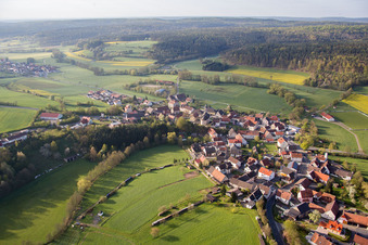 Village - view on the edge of agricultural fields and farmland in Proelsdorf in the state Bavaria, Germany