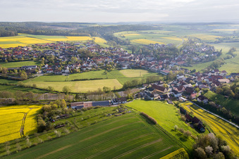 Village - view on the edge of agricultural fields and farmland in Schoenbrunn im Steigerwald in the state Bavaria, Germany