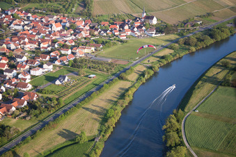 Village on the bank areas of the river Main with sport boat and paraglider in Kolitzheim in the state Bavaria