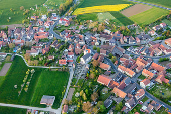 Village - view on the edge of agricultural fields and farmland in Schallfeld in the state Bavaria, Germany