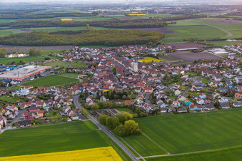 Aerial photograpy of Village - view on the edge of agricultural fields and farmland in Grettstadt in the state Bavaria, Germany