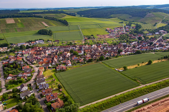 Aerial photograpy of Village - view behind motorway A3 on the edge of agricultural fields and farmland in the district Dertingen in Wertheim in the state Baden-Wurttemberg