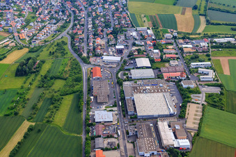 Aerial view of Commercial area south of the B27 with REWE Center and Motorradhaus Ebert eK in Höchberg in the state Bavaria, Germany